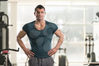 Portrait of a Young Physically Fit Man in Green T-shirt Showing His Well Trained Body - Muscular Athletic Bodybuilder Fitness Model Posing After Exercises