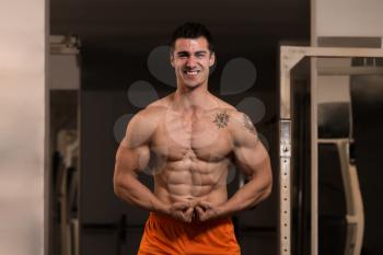 Bodybuilder Posing In Different Poses Demonstrating Their Muscles - Male Showing Muscles Straining - Beautiful Muscular Body Athlete