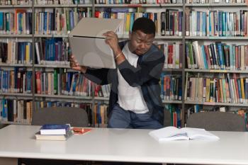 African Male Student Throwing Laptop And Want To Destroy It - Shallow Depth Of Field