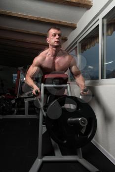 Bodybuilder Doing Heavy Weight Exercise For Back On Machine
