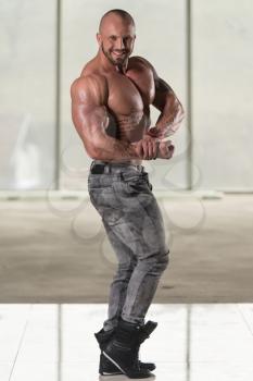 Healthy Young Tattoo Man Standing Strong In Pants And Flexing Muscles - Muscular Athletic Bodybuilder Fitness Model Posing After Exercises