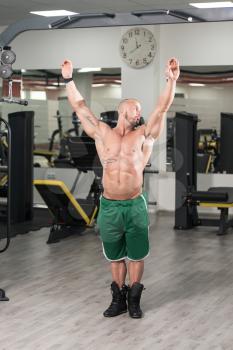 Young Man Performing Hanging Leg Raises Exercise - One Of The Most Effective Ab Exercises