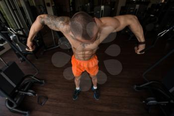 Bodybuilder Is Working On His Chest With Cable Crossover In Gym