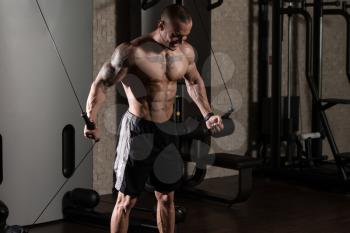 Man Is Working On His Chest With Cable Crossover In A Modern Gym