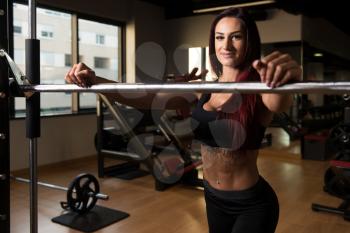 Woman Preparing To Working Out Legs With Barbell In A Gym - Squat Exercise