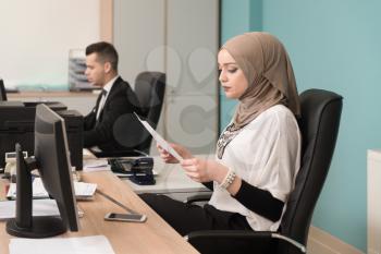 Happy Young Business Man And Muslim Woman Work In Modern Office On Computer