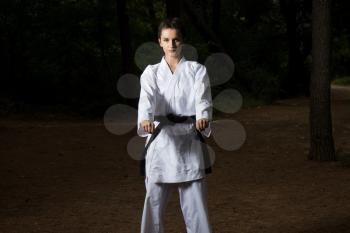 Young Woman Dressed In Traditional Kimono Practicing Her Karate Moves in Wooded Forest Area - Black Belt