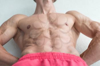 Handsome Young Man Standing Strong Flexing Muscles - Muscular Athletic Bodybuilder Fitness Model Posing After Exercises