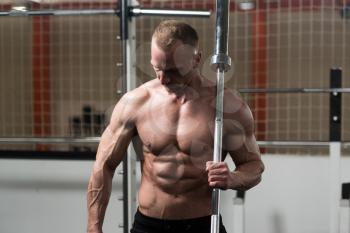 Portrait Of A Physically Fit Man Showing His Well Trained Body In Gym