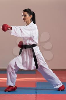 Young Woman Practicing Her Karate Moves - White Kimono - Black Belt