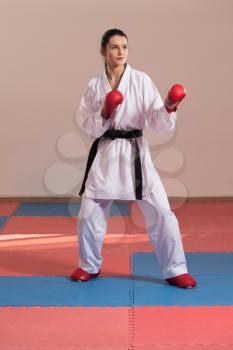 Young Woman Practicing Her Karate Moves - White Kimono - Black Belt