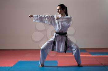 Young Woman Practicing Her Karate Moves - White Kimono - Black Belt