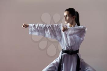 Young Woman Practicing Her Karate Moves - White Kimono - Black Belt