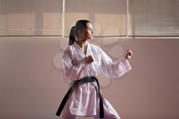 Young Woman Dressed In Traditional Kimono Practicing Her Karate Moves - Black Belt