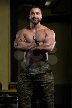 Handsome Young Man Standing Strong In Army Pants And Flexing Muscles - Muscular Athletic Bodybuilder Fitness Model Posing After Exercises