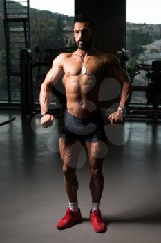 Portrait Of A Young Physically Fit Tattoo Man Showing His Well Trained Body - Muscular Athletic Bodybuilder Fitness Model Posing After Exercises