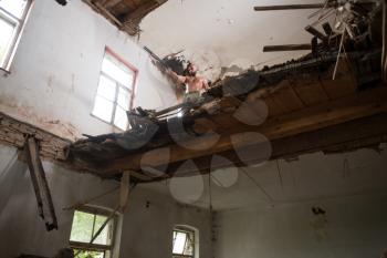 Action Hero Muscled Man Holding Machine Gun - Standing In Abandoned Building Wearing Army Pants