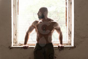 Portrait of a Physically Fit Man Showing His Well Trained Body - Muscular Athletic Bodybuilder Fitness Man Posing After Exercises Inside Ruins