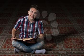 Humble Muslim Man Is Reading The Koran In The Mosque