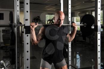 Man Working Out Legs With Barbell In A Gym - Front Squat Exercise