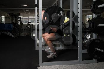 Healthy Fitness Man Working Out Legs With Barbell In A Gym - Front Squat Exercise