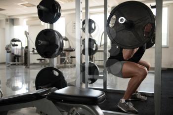 Man Working Out Legs With Barbell In A Gym - Front Squat Exercise