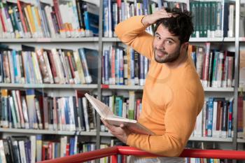 Handsome Man With Dark Hair Standing in the Library - Student Preparing Exam and Learning Lessons in School Library