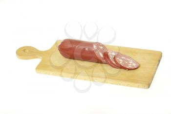 Royalty Free Clipart Image of Smoked Sausage on a Cutting Board