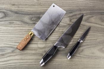 Butcher, paring and large knife set on fading white ash wood
