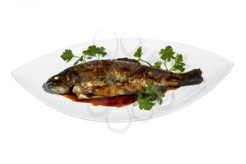 Fried trout with sweet sauce on top decorated by parsley in white dish