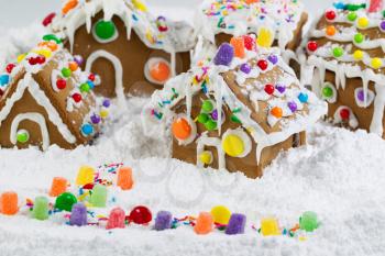Horizontal photo of Gingerbread houses surrounded by powered snow