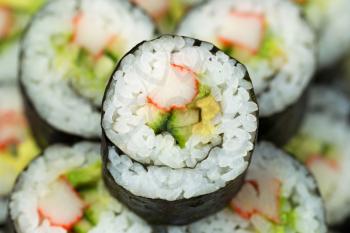 Extreme horizontal Closeup photo of a single California hand roll sushi with focus in center 