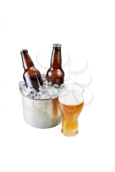 Vertical photo of freshly poured beer in large glass and bottled beer in stainless steel bucket filled with ice isolated on white