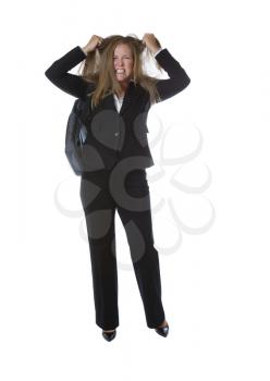 Business woman, expressing anger by pulling her hair, with laptop carry case on her shoulder while isolated on white