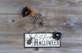 Top view of Halloween sign with scary hand on rustic wood