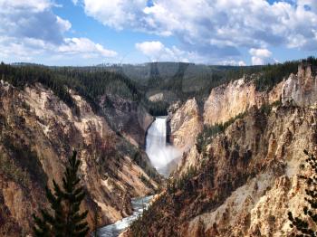  Horizontal image of Yellowstone canyon falls during a beautiful summer day surrounded by pine trees and blue sky with clouds