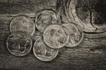 Vintage concept of old nickel coins on rustic wood