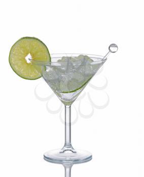 Cocktail drink with stir stick and lime slice isolated on white with reflection.  