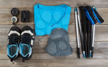 Basic gear, mostly blue color coordination, for outdoor walking on rustic wooden boards. 