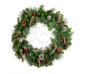 Christmas wreath isolated on white background. Decorated with candy canes, cones and red berries. 
