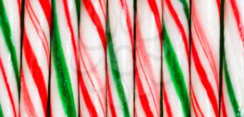 Candy cane sticks aligned next to each other. 