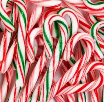 Filled frame of peppermint candy canes. Layout in square format on white background. Christmas concept. 