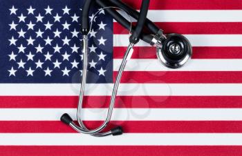 United States of America flag with stethoscope. USA health concept. Overhead view in horizontal layout.