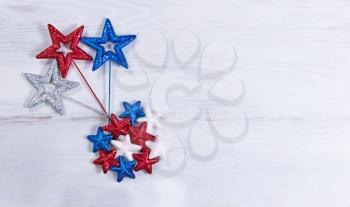 Stars in exploding pattern with USA national colors on rustic white wooden boards. Fourth of July holiday concept for United States of America.  