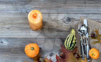 Dinner place setting for Thanksgiving Autumn holiday in horizontal layout on rustic wooden boards. 