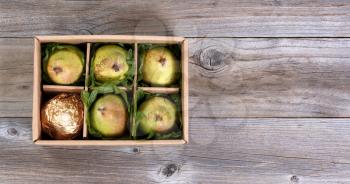 Overhead view of fresh pears in gift box on rustic wood with copy space.