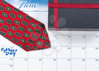 Fathers Day holiday marked on calendar with gift box   