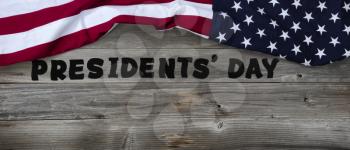 Presidents day in large text letters on rustic wooden boards with US flag in top border 