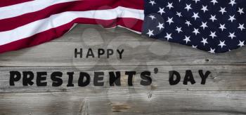 Happy Presidents day in large text letters on rustic wooden boards with US flag in top border 