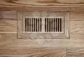 Wooden floor vent on red oak floor 
